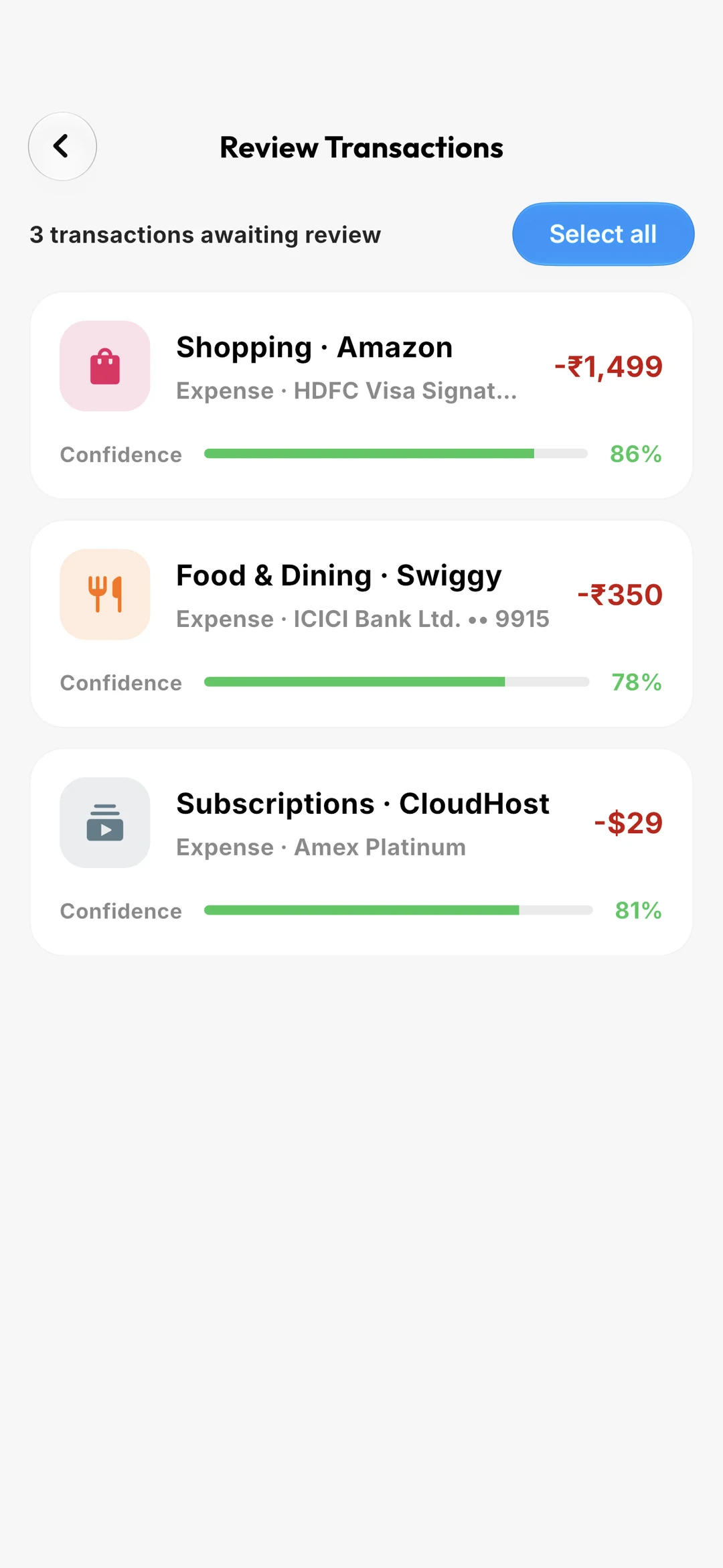 The review queue: three auto-imported transactions awaiting confirmation, each with a confidence score.